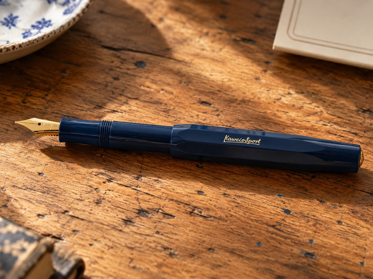 Kaweco Classic Sport fountain pen in navy on a wooden desk